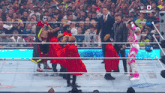a group of wrestlers are in a ring with a sign that says wwe