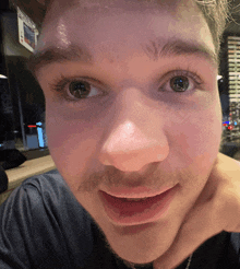 a close up of a man 's face with the word pepsi on the wall