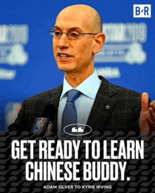 a man in a suit and tie speaking into a microphone with the words " get ready to learn chinese buddy " below him