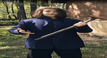 a girl in a blue jacket is holding a hammer