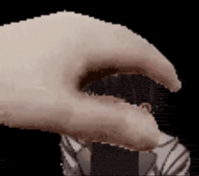 a close up of a person 's hand with a black background and a claw .