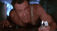 a man with blood on his face is holding a lighter in his right hand
