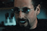 a man with a beard wearing sunglasses is smiling