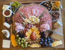 a turkey shaped cutting board filled with meats cheeses and fruit