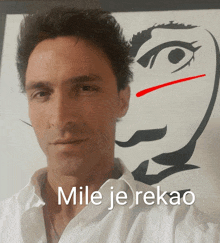 a man is standing in front of a drawing of a face and the words mile je rekao are above him