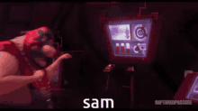 a man is playing a video game in front of a screen that says sam on it .