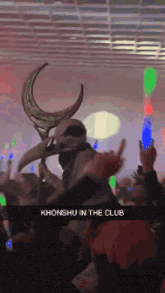 a person in a skeleton mask is dancing in a club with a caption that says khonshu in the club