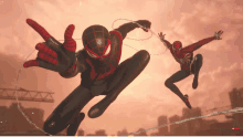 two spider-man are flying through the air and one is giving a rock sign