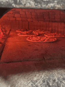 several pizzas are being cooked in an oven