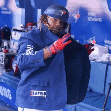 a baseball player wearing a blue jacket with the word barrio on it