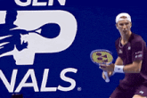 a man holding a tennis racquet in front of a yonex logo