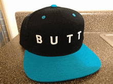 a black hat with the word butt written on it