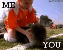 a boy in an orange shirt is petting a dog on a field with the words " me you "