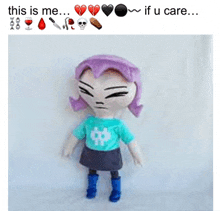 a stuffed doll with purple hair and a blue shirt that says " this is me "