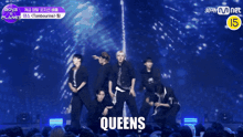 a group of young men are posing for a picture with the word queens in the corner