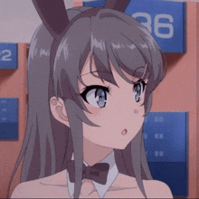 a girl with long hair and bunny ears is wearing a bow tie and a bunny costume .