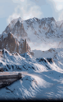 a snowy mountain landscape with a few rocks in the foreground and a few trees in the background