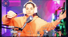 a woman wearing headphones is holding a stick in front of a microphone while playing a video game