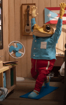 a stuffed frog is standing on a yoga mat in a room