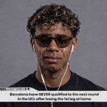 a man wearing sunglasses and headphones is crying
