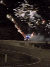 a car is driving through a fireworks display