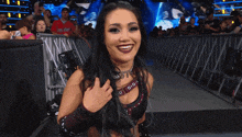 a female wrestler stands in front of a sign that says summer slam