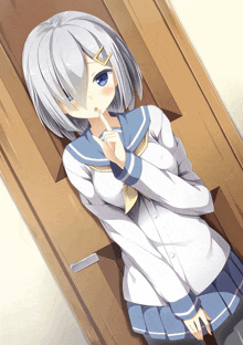 a girl with white hair and blue eyes is standing in front of a door