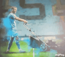 a man is pushing a lawn mower on a soccer field with a blue background and the words imgplay at the bottom