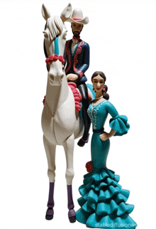 a figurine of a man riding a horse and a woman in a blue dress