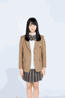 a girl in a school uniform with a patch that says ' seed & flower llc ' on it