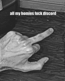 a black and white photo of a person 's hand pointing at something with the caption all my homies fuck discord