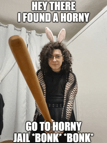 a woman wearing bunny ears is holding a baseball bat and says hey there i found a horny go to horny