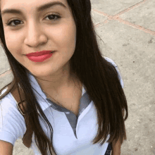 a close up of a woman taking a selfie on a sidewalk .