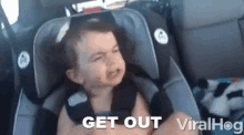 a baby is sitting in a car seat with the words get out viralhog below it