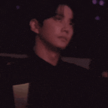 a woman in an off the shoulder dress is standing next to a man in a black shirt