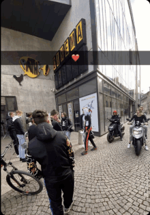 a group of people standing outside of a building that says cinema