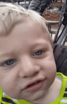 a close up of a young boy 's face with blue eyes