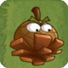 a cartoon pine cone with a green leaf on top of it is sitting on top of a green field .