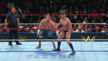 two men in a wrestling ring with the word riyadh season on the ground