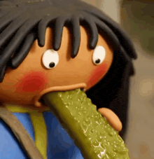 a cartoon character is eating a pickle with his tongue hanging out .