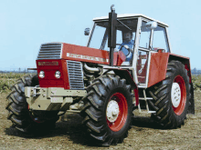 a man is driving a red and white tractor that says zurich