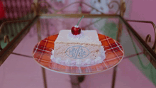 a piece of cake with a cherry on top that says by bb ice