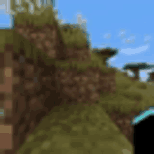 a blurry picture of a minecraft world with a cliff and grass