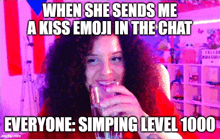 a woman with curly hair is drinking a glass of water while making a meme about a kiss emoji in a chat .