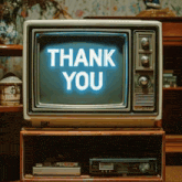an old television displays the words thank you on the screen