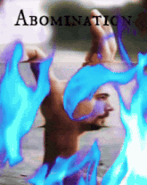a man is surrounded by blue flames with the word abomination above him