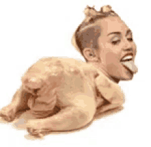 a woman is sticking her tongue out while laying on a chicken .