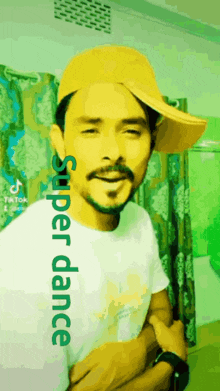 a man wearing a yellow hat and a white shirt with the words super dance written on it .