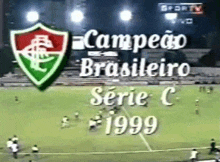 a soccer game is being played on a field with the year 1999 on the bottom