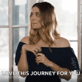 a woman is standing in front of a window and saying `` love this journey for you `` .